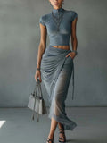 Conjunto azul de top y falda de malla de Noura Madrid